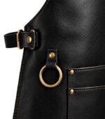 Black leather apron with gold hardware and stitching