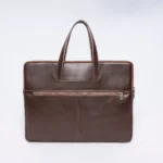 Brown leather briefcase with double zippers and top handles