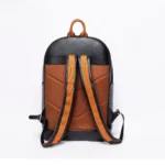 Black and tan leather backpack with orange strap details