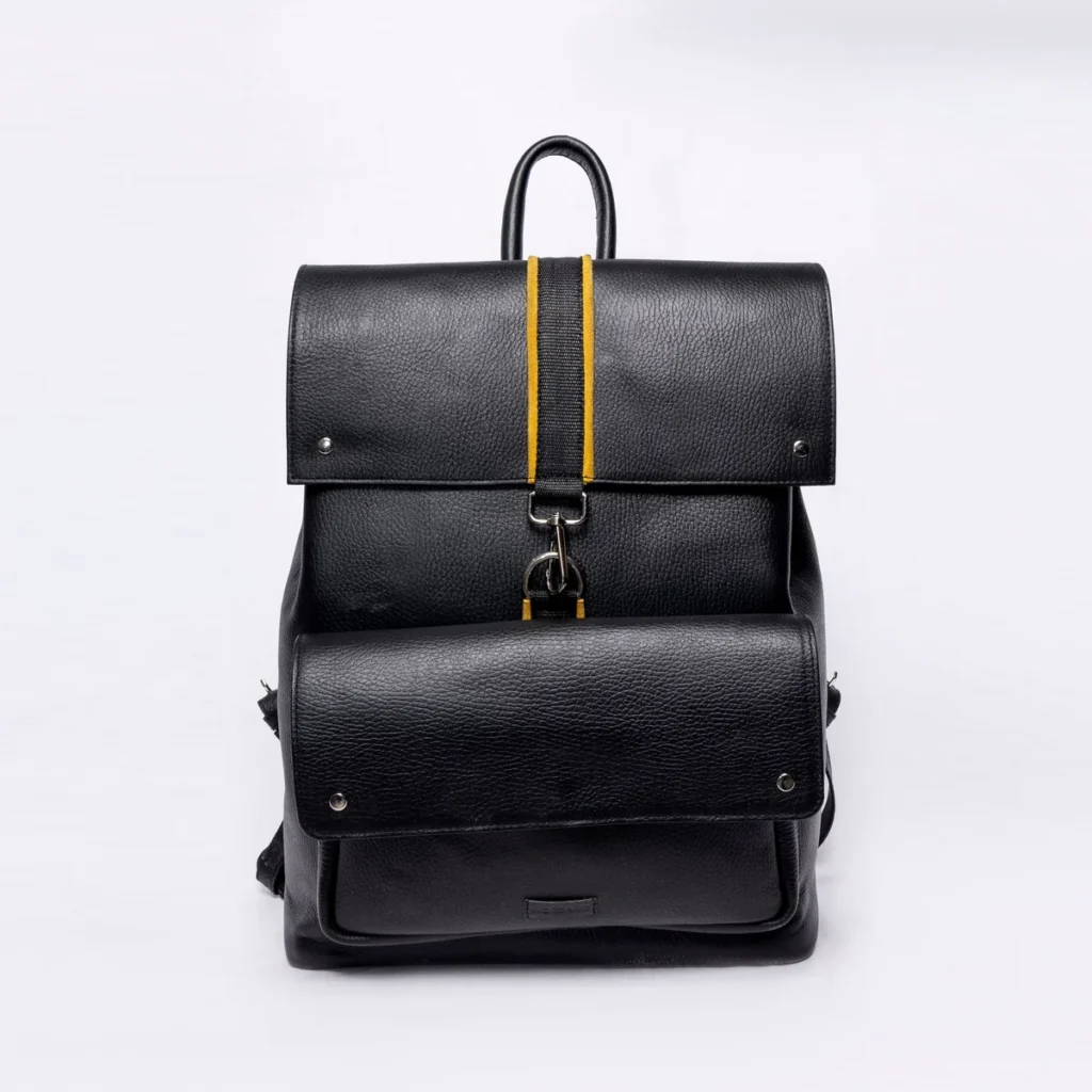 Black leather backpack with yellow accent strap and silver hardware