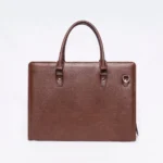 Brown pebbled leather briefcase with double handles and a side D-ring