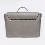 Gray pebbled leather satchel with brass zipper detail and top handle