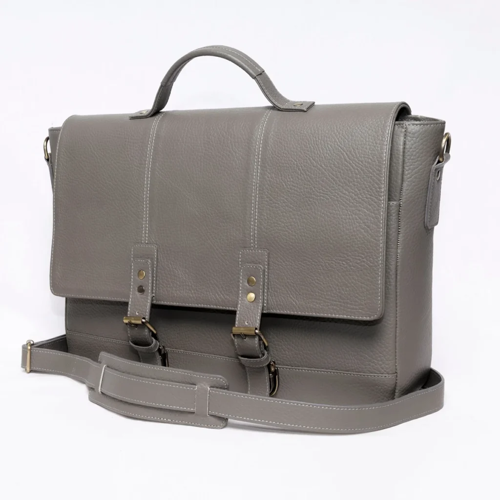 Gray leather satchel with white stitching and brass buckles