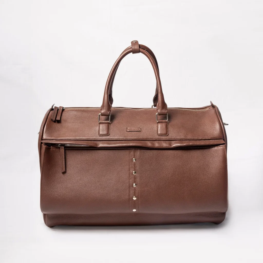 Brown leather duffel bag with silver stud detail and zippered compartments