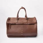 Brown leather duffel bag with silver stud detail and zippered compartments
