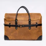 Brown leather briefcase with black accents and handles