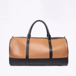 Two-tone leather duffel bag with black handles and accents