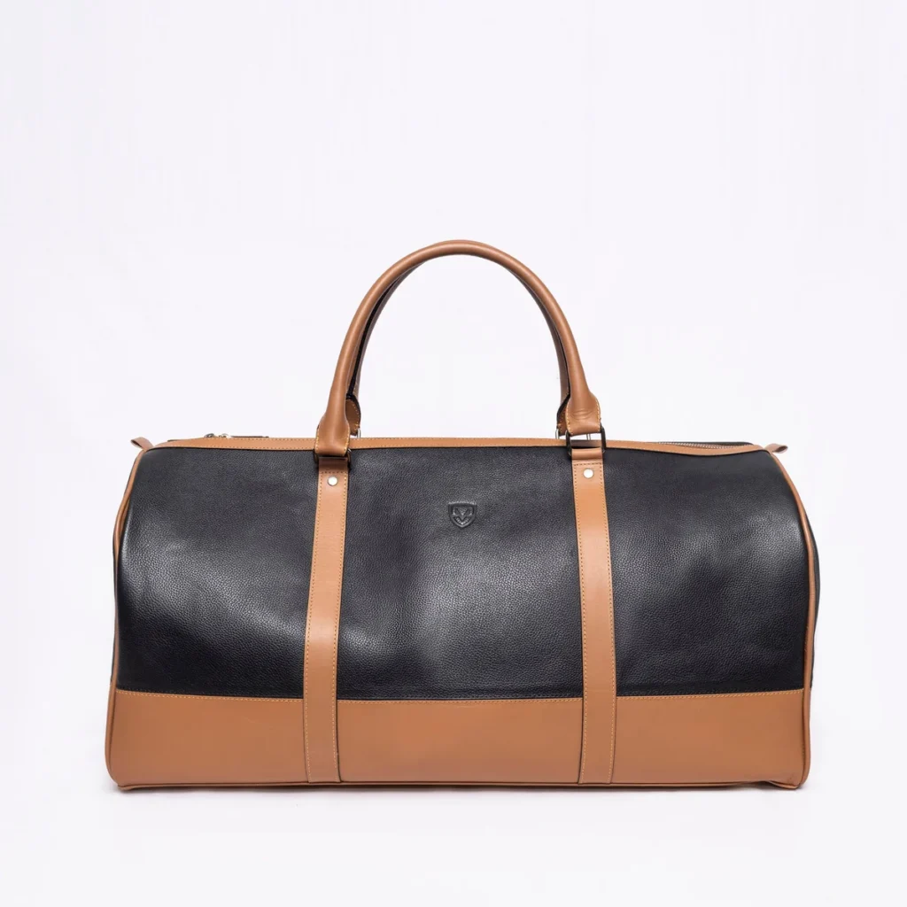 Black and tan leather duffel bag with twin handles