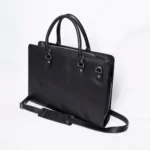 Black leather briefcase with top handles and detachable shoulder strap