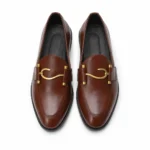 Brown leather loafers with gold horsebit detail