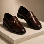 Brown leather loafers with gold horsebit detail