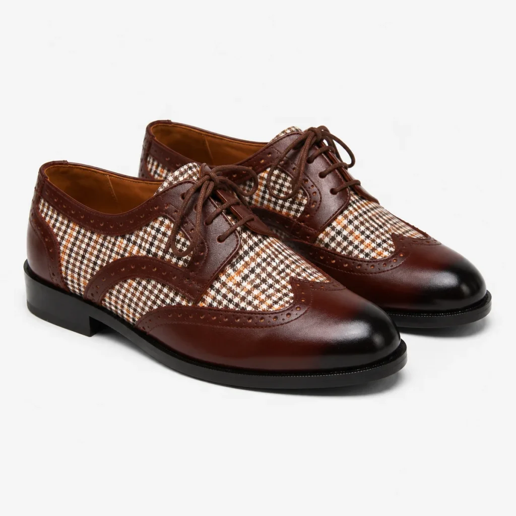 Brown leather wingtip shoes with houndstooth fabric detail