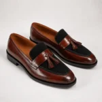 Brown leather tassel loafers with black suede accents