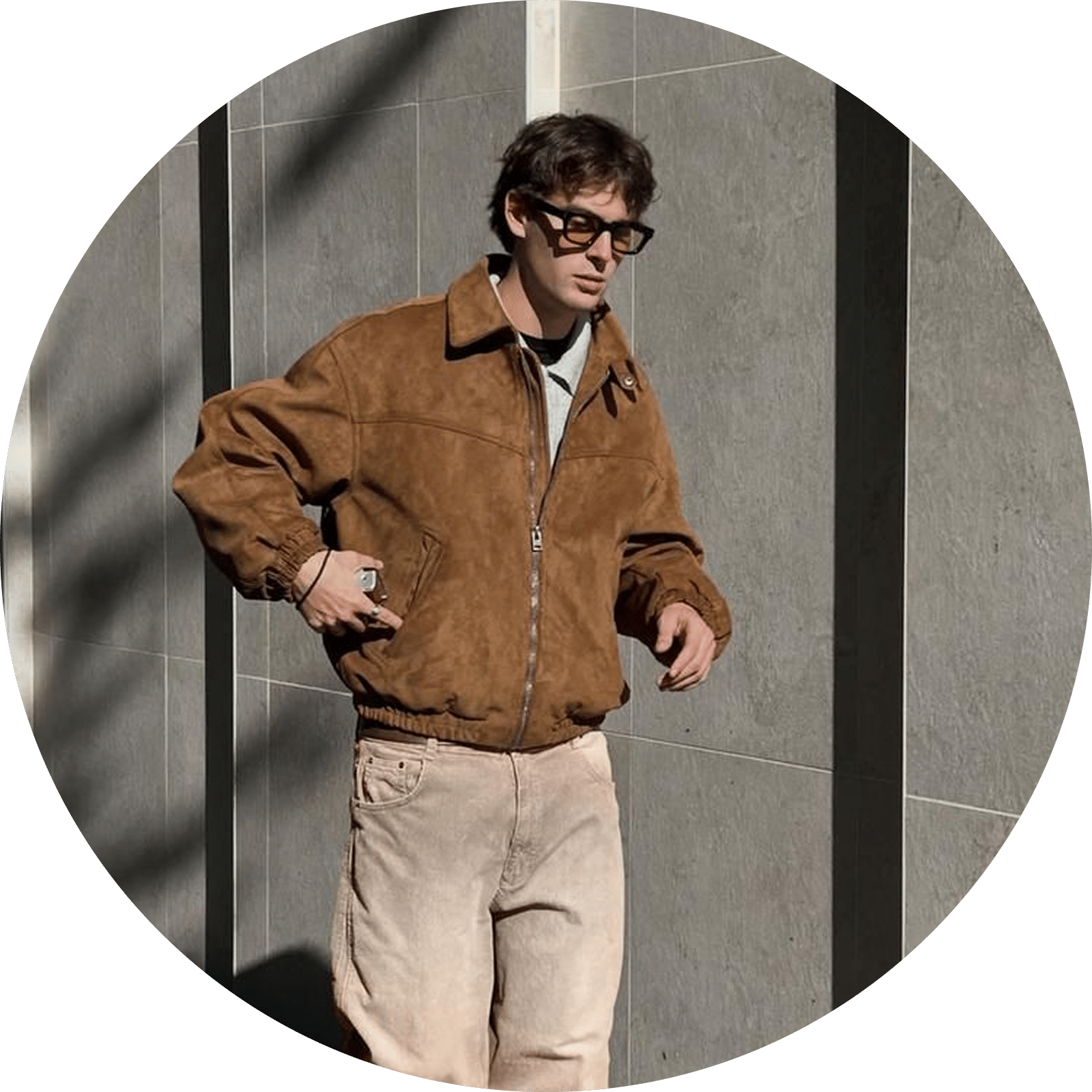Brown suede jacket with light-colored pants and sunglasses