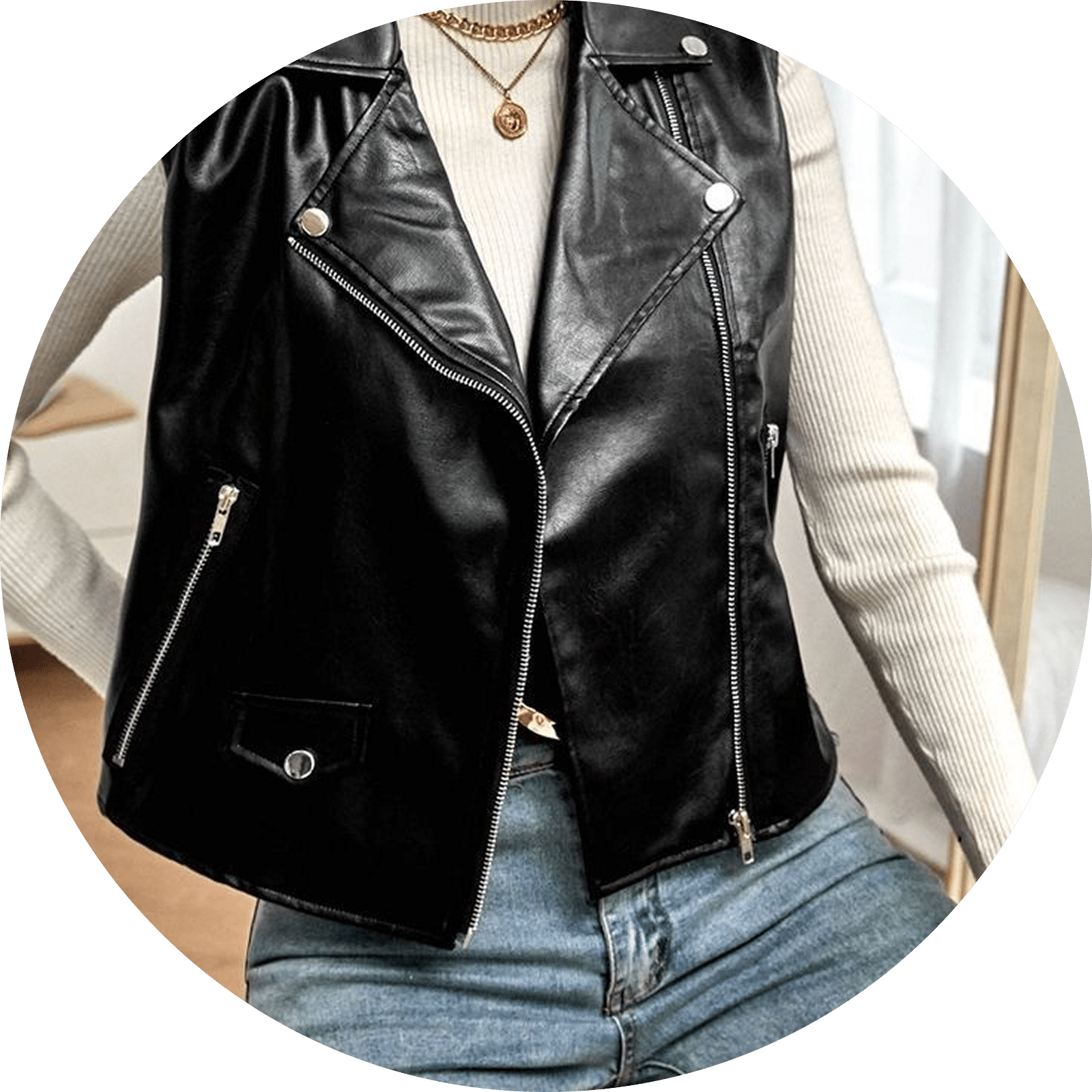 Black faux leather moto vest with silver zippers and a gold chain necklace