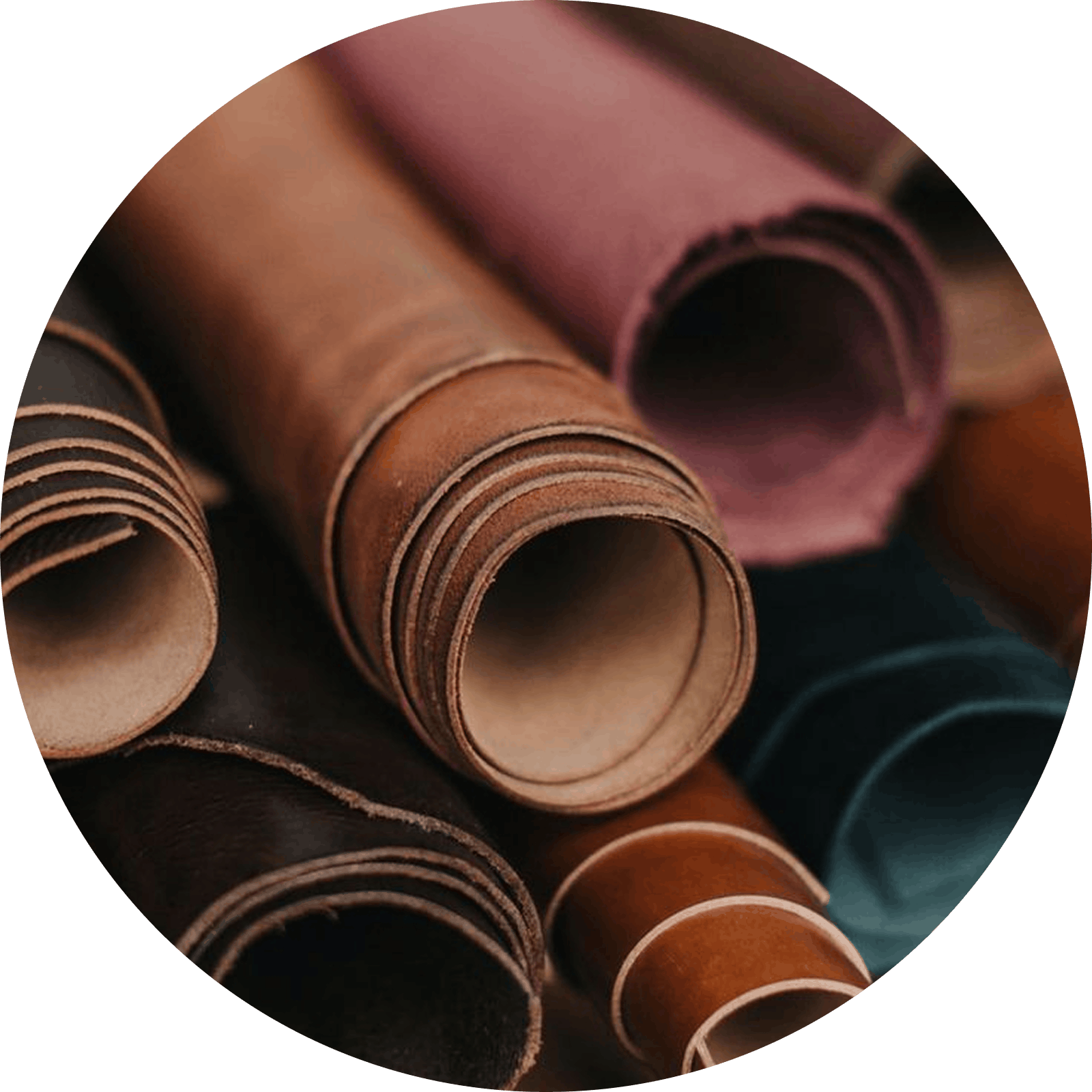 Rolled leather hides in various brown, pink, and teal colors