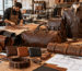 Leather workshop with various leather goods, including a jacket, bags, and wallets