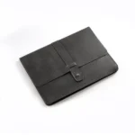 Dark gray leather clutch with strap closure