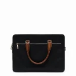 Black laptop bag with brown leather handle and silver hardware