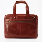 Brown pebbled leather briefcase with brass hardware and a zippered front pocket