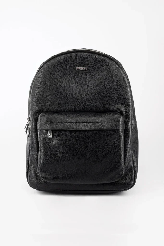 Black textured leather backpack with front pocket and metal logo