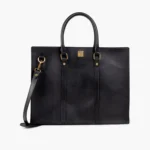 Black leather tote bag with gold hardware and detachable strap